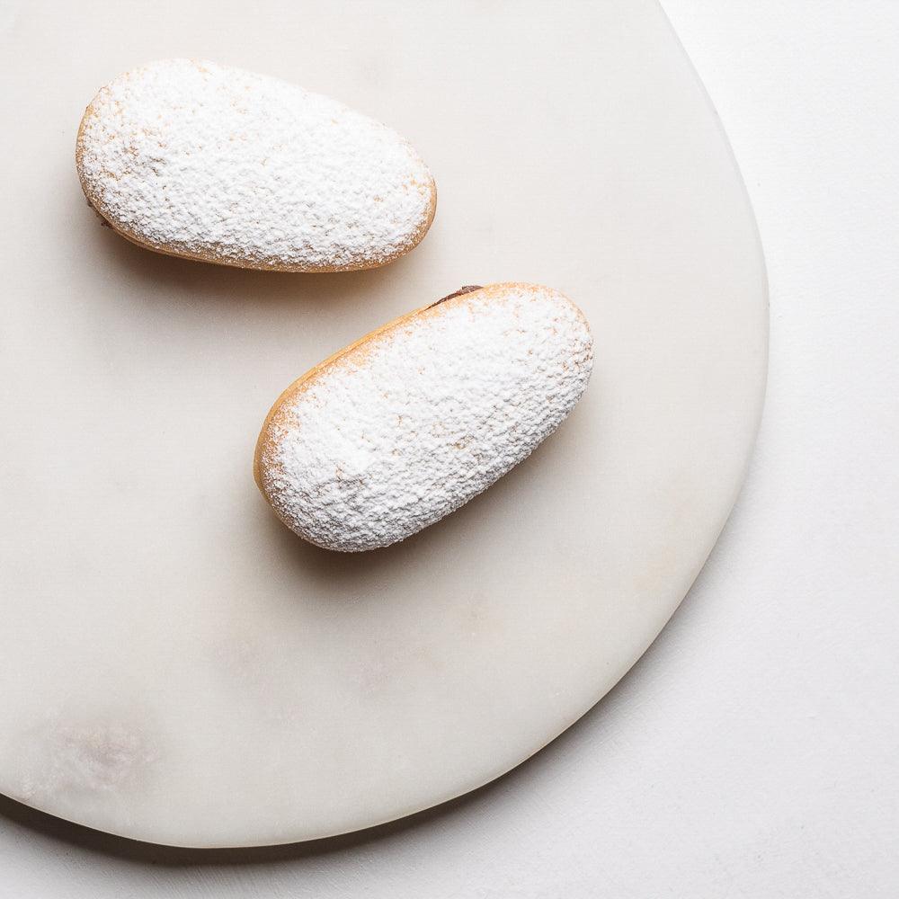 Pasticceria Papa's Baci Di Dama Lungo Biscuits covered in icing sugar