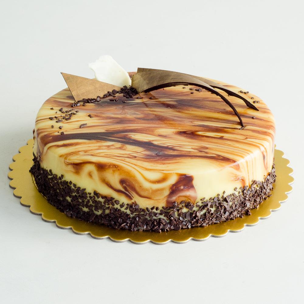 Pasticceria Papa’s Chocolate Marble Mud Cake is made with chocolate marbled sponge, dark chocolate ganache filling, and finished with dark & white chocolate marbled ganache and chocolate decorations.