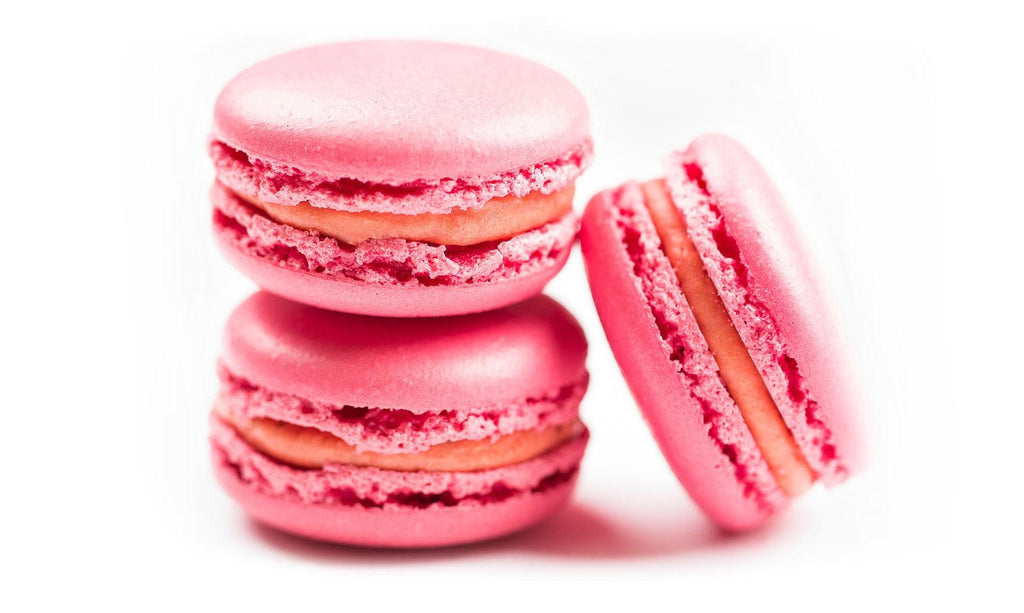 Strawberry Macarons made with Two tiny mounds of almond meringue sandwiched, between smooth strawberry and white chocolate ganache in 12 pack