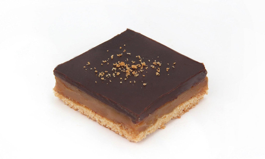 Square Gluten Free Caramel Slice in a 4 pack with biscuit base, fudgy caramel centre and chocolate on top