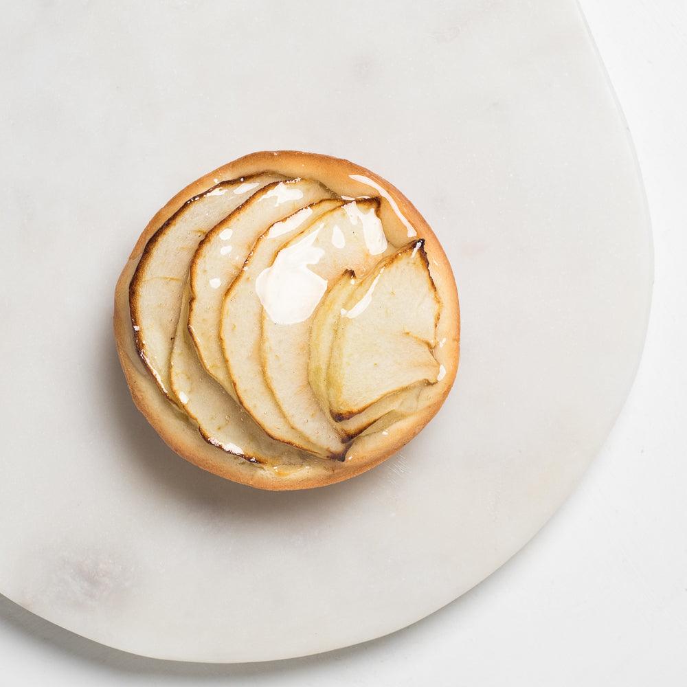 Pasticceria Papas Small single serving apple tart with sliced apples glaze top view